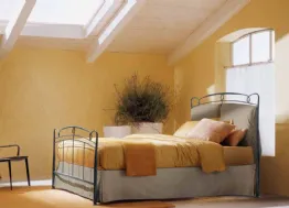 Letto in ferro battuto con testiera in tessuto imbottito e contenitore Versilia di Bontempi